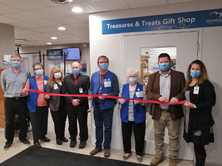 A photo of the grand opening of the Treasures and Treats gift shop, located just inside the main entrance of Stevenson Memorial Hospital